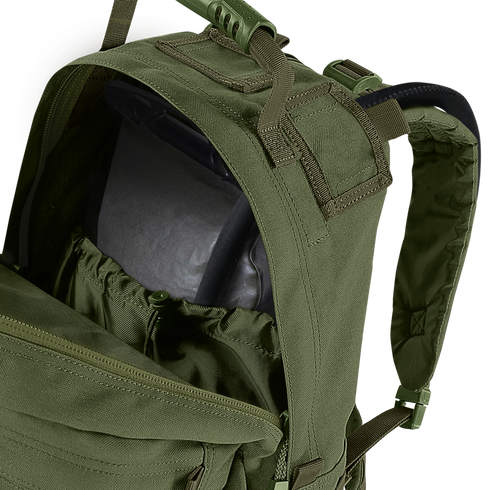 A close-up of the Condor Medium Assault Backpack 30L in olive green shows its top compartment unzipped, revealing an internal hydration bladder.