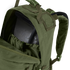 A close-up of the Condor Medium Assault Backpack 30L in olive green shows its top compartment unzipped, revealing an internal hydration bladder.
