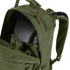 A close-up of the Condor Medium Assault Backpack 30L in olive green shows its top compartment unzipped, revealing an internal hydration bladder.