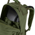 A close-up of the Condor Medium Assault Backpack 30L in olive green shows its top compartment unzipped, revealing an internal hydration bladder.