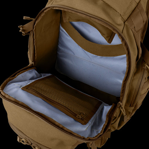 The Condor Urban Go Backpack 33L is shown open, revealing a spacious main compartment with light blue lining and a mesh zippered pocket inside.