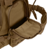 A close-up of the Condor Urban Go Backpack 33L in brown, featuring a partially open zippered front pocket that reveals its inner lining—ideal for tactical, military, or law enforcement use.
