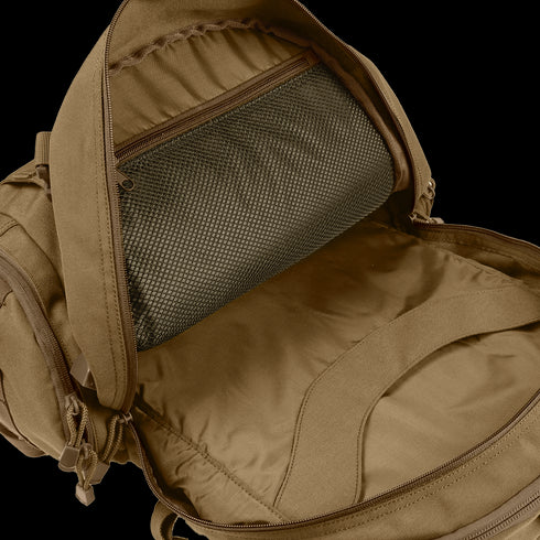 The Condor Commuter Backpack 26L, ideal for military or bushcraft use, features an open design with a spacious main compartment and interior mesh zippered pocket.
