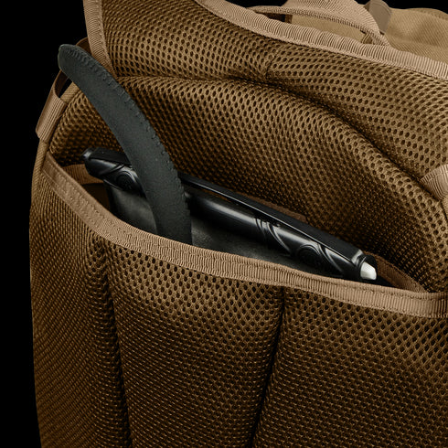 A brown mesh-textured pocket of the Condor Commuter Backpack 26L holds a black tablet with a case and stylus as part of an EDC setup.