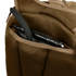 A close-up of the Condor Commuter Backpack 26L’s brown mesh pocket holding a black tablet with a protective case.