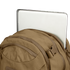 A silver laptop partially sticks out of the main compartment of the Condor Commuter Backpack 26L in tan, set against a plain background.