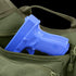 A blue plastic training gun is partially visible inside an open green Condor EDC Bag.