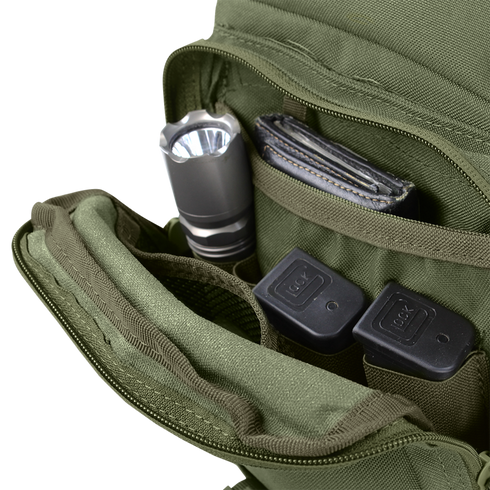 A Condor EDC Bag | SALE with an open green pocket holds a flashlight, wallet, and two Glock pistol magazines neatly organized in separate compartments.