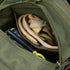 An open green Condor EDC Bag with a zipper reveals a pair of tan Condor work gloves and a yellow-and-black handheld device inside.