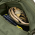 An open green Condor EDC Bag with a zipper reveals a pair of tan Condor work gloves and a yellow-and-black handheld device inside.