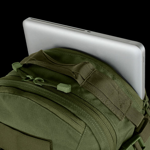 A silver laptop partly tucked into the main compartment of the Condor Venture Backpack 27.5L in olive green.