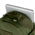 A silver laptop partly tucked into the main compartment of the Condor Venture Backpack 27.5L in olive green.
