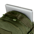 A silver laptop partly tucked into the main compartment of the Condor Venture Backpack 27.5L in olive green.