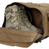 A pair of tactical camouflage military boots placed inside an open Condor Colossus Duffle Bag 60L.