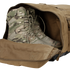 A pair of tactical camouflage military boots placed inside an open Condor Colossus Duffle Bag 60L.