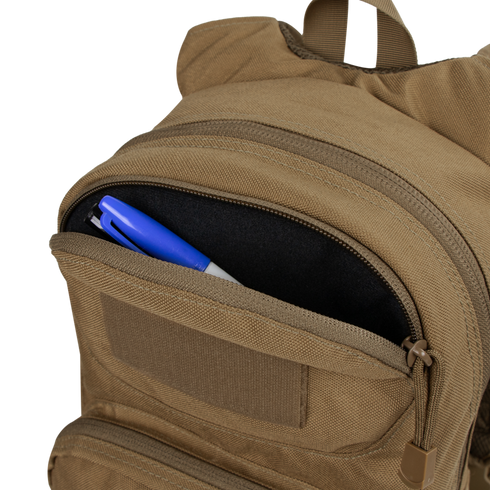 The Condor Fuel Hydration Backpack 18L in tan features a partially open zippered pocket, revealing a blue and white pen and black marker—ideal for organized gear storage on the move.