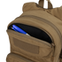 The Condor Fuel Hydration Backpack 18L in tan features a partially open zippered pocket, revealing a blue and white pen and black marker—ideal for organized gear storage on the move.