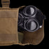 A Condor Gas Mask Leg Rig, partially visible inside an open brown canvas pouch, is commonly used by military or law enforcement personnel.