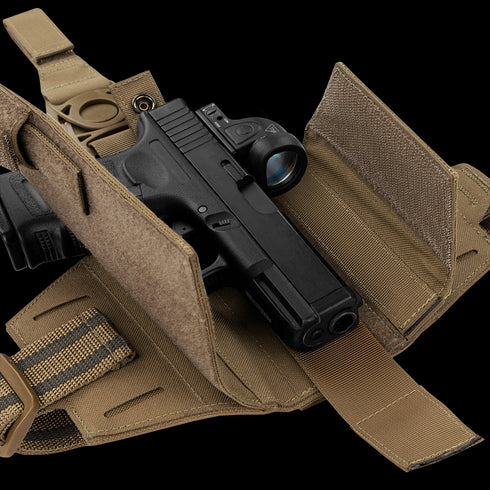 The Condor LCS RDS Leg Holster, shown in tan, securely holds a black handgun with optic using straps and Velcro closures, making it ideal for law enforcement or military use.