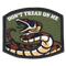 The Condor Dont Tread On Me Patch features a coiled rattlesnake and bold text on an olive green background—ideal for bushcraft gear or the shooting range.