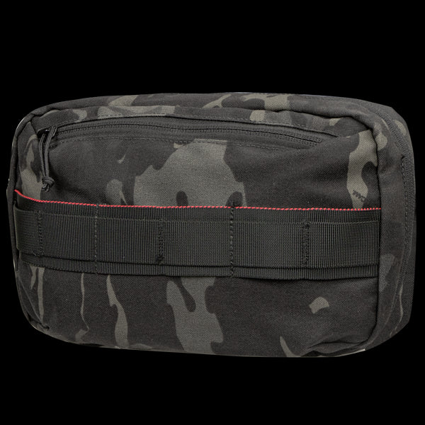 The Condor Tech Pouch - MultiCam Black is a rectangular pouch featuring black and gray camouflage, red stitching, a front zipper, and webbing loops on the front.