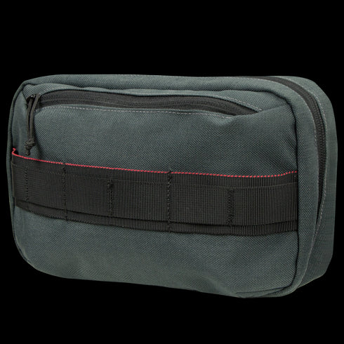 The Condor Tech Pouch features dark green fabric, a black zipper, black webbing, and a red stitched detail—perfect for EDC or tactical use by military and law enforcement professionals.