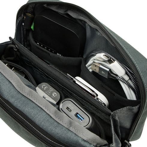 The Condor Tech Pouch features zippered compartments to organize tech accessories like cables, chargers, a power bank, and various gadgets.