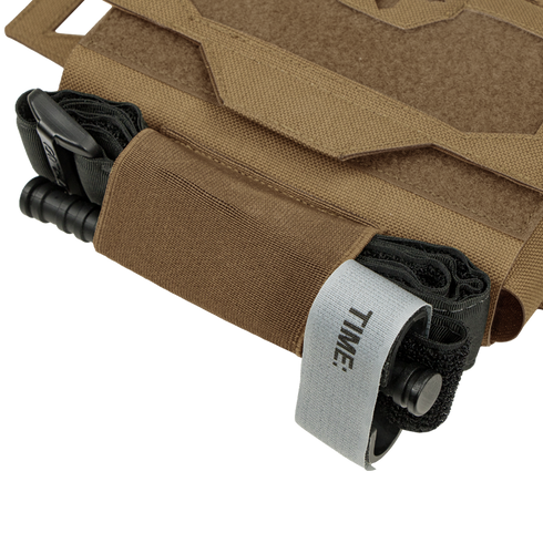 A tan Condor Micro TK Pouch Gen II holds a black tourniquet with a visible gray TIME: strap on one end.