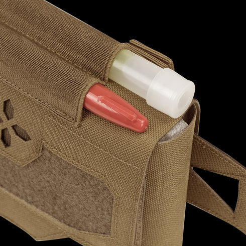 A close-up of the Condor Micro TK Pouch Gen II in tan, showing a red pen and white-capped tube inside, plus hook-and-loop patch and strap—perfect for organizing first responder essentials.