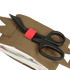 A pair of black trauma shears with a red band, favored by first responders, rests on a Condor Micro TK Pouch Gen II with a partially open zippered compartment.
