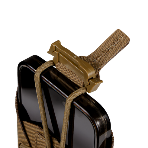 A black smartphone is secured in a Condor LACE Phone Pouch, featuring a tan tactical holder with an elastic cord and plastic buckle, displayed against a plain white background.