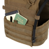 A tan Condor Gunner Plate Carrier holds a black pen, a black notebook, and a green Field Notes notebook—everyday essentials for first responders—with a hydration tube attached.