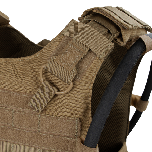 Close-up of the Condor Gunner Plate Carriers tan shoulder strap, featuring MOLLE webbing, D-ring, hook-and-loop fasteners, and hydration tube—perfect for bushcraft or law enforcement EDC.