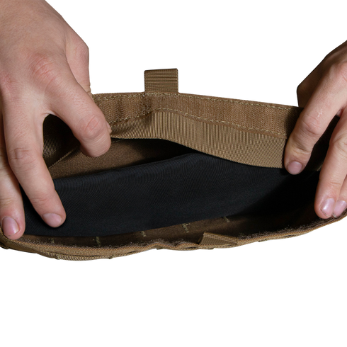 Two hands open a tan Enforcer Releasable Plate Carrier by Condor, revealing black interior details and MOLLE webbing against a white background.