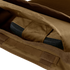 A close-up view of the Condor EXO Plate Carrier Gen II in brown fabric with an open zipper, showing a partially enclosed black object inside.
