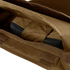A close-up view of the Condor EXO Plate Carrier Gen II in brown fabric with an open zipper, showing a partially enclosed black object inside.