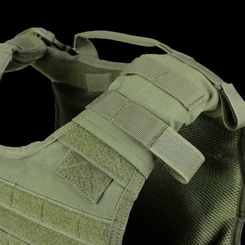 Close-up view of the Condor Defender Plate Carrier, a green tactical vest featuring adjustable shoulder straps, Velcro patches, and webbing detail.