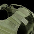 Close-up view of the Condor Defender Plate Carrier, a green tactical vest featuring adjustable shoulder straps, Velcro patches, and webbing detail.