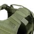 Close-up view of the Condor Defender Plate Carrier, a green tactical vest featuring adjustable shoulder straps, Velcro patches, and webbing detail.
