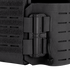 Close-up of the Condor Vanquish RS Plate Carrier in black, featuring a secured radio attached to the side with nylon straps and a cord.