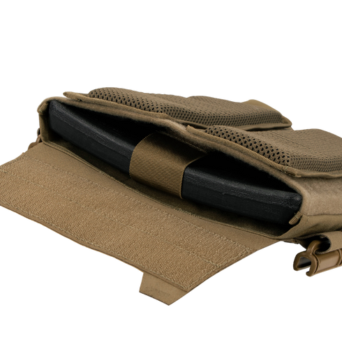 A close-up of the Condor Vanquish RS Plate Carrier’s tan pocket with a black ballistic plate partially inserted and held by an elastic strap.
