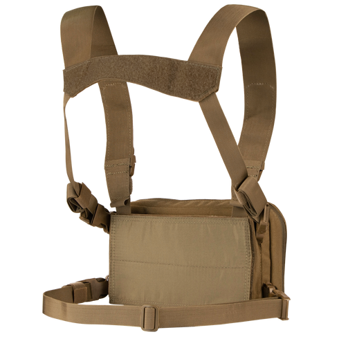 The Condor Stowaway Chest Rig is a tan military chest rig with adjustable shoulder and waist straps, and a front pouch for carrying tactical gear or supplies.