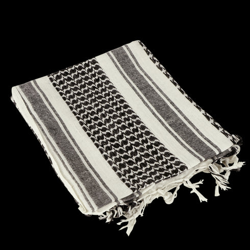 The Condor Shemagh in black & white features a bold pattern and fringed edges, ideal as stylish headwear or a protective layer.