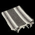 The Condor Shemagh in black & white features a bold pattern and fringed edges, ideal as stylish headwear or a protective layer.