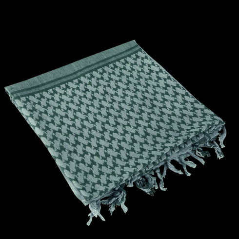 The Condor Shemagh in Foliage & Green features a classic pattern, made from 100% cotton with knotted fringe edges—ideal for use as traditional headwear.