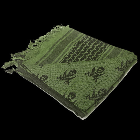 The Condor Shemagh - Pirate is a green and black patterned scarf with fringed edges, featuring geometric and skull designs—an excellent EDC accessory for bushcraft or the shooting range.