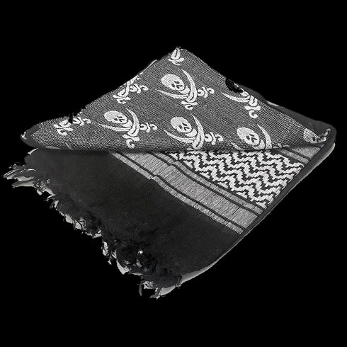 The Condor Shemagh - Pirate is a folded black and gray scarf with fringe edges, featuring skull and crossbones alongside geometric patterns—a bold accessory inspired by military style.