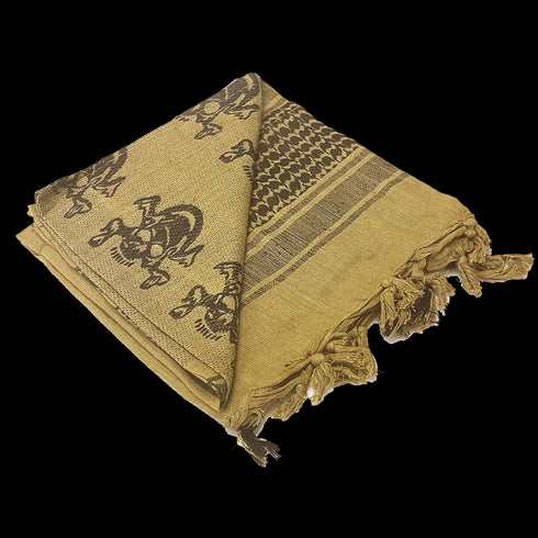 The Condor Shemagh - Skull is a folded tan scarf featuring black skull motifs, geometric patterns, and fringed edges.