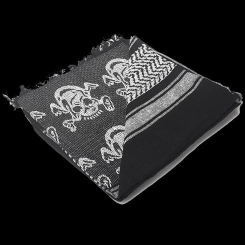 The Condor Shemagh - Skull is a folded black and white scarf with skull patterns and geometric designs, finished with frayed edges on one side.
