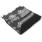 The Condor Shemagh - Skull is a folded black and white scarf with skull patterns and geometric designs, finished with frayed edges on one side.